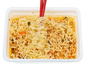 eating of instant ramen by red chopsticks from lunch box isolated on white background