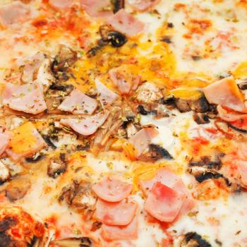 background from italian pizza with mushrooms and ham close up
