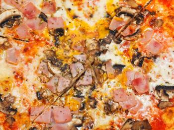 background from italian pizza with mushrooms and prosciutto cotto close up