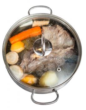simmer of beef broth with seasoning vegetables in steel pan isolated on white background