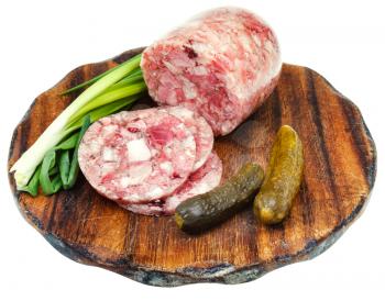 head cheese and pickled cucumbers on wooden cutting board isolated on white background
