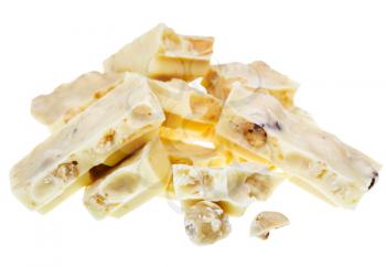 broken white chocolate with hazelnuts close up isolated on white background