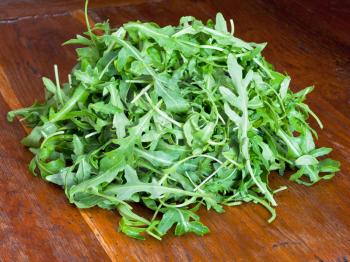 fresh arugula salad on wooden table