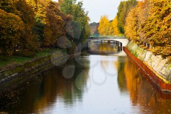 bridge and fall of leaves on Landwehrkanal in Berlin in autumn day