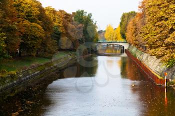 view of bridge and leaves fall on Landwehrkanal in Berlin in autumn day