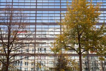 reflection of urban residential house in the facade of the glass building