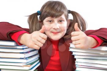 joyful schoolgirl did schoolwork and shows thumb-up