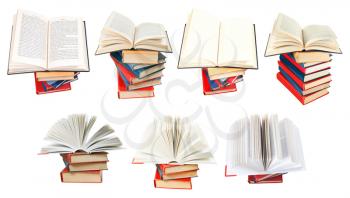 set from fan opened books on top of stack of books isolated on white background