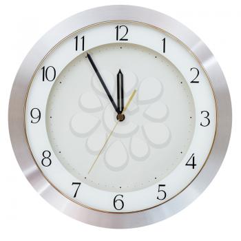 at five minutes to twelve on the dial round wall clock