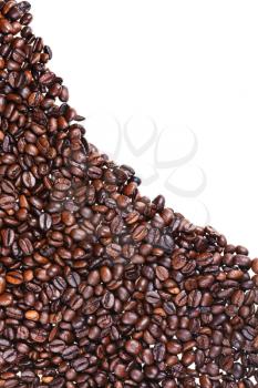 hill slope from roasted coffee beans close up on white background