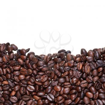 level from roasted coffee beans close up on white background