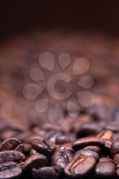 strong roasted coffee beans black background with focus foreground