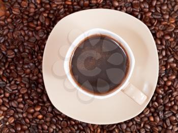 top view mug of coffee and roasted coffee beans