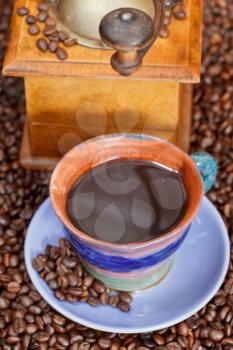 above view mug of coffee and roasted coffee beans with retro wooden manual mill