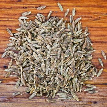 top view of dried cumin seeds on wooden table