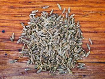 dried cumin seeds spice on wooden table