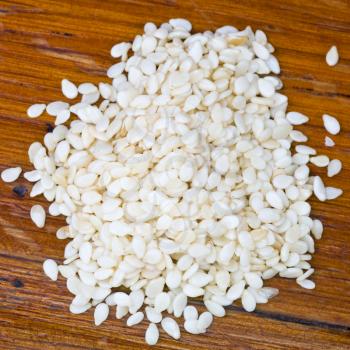 top view of raw sesame seeds on wooden table