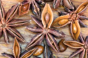 macro view of dried anise seeds spice on wooden table