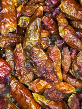 background from dried small hot spicy red peppers close up