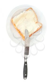 top view of bread and butter sandwich on white plate, knife isolated on white background