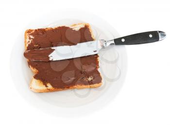 top view of fresh toast with chocolate spread on white plate, table knife isolated on white background