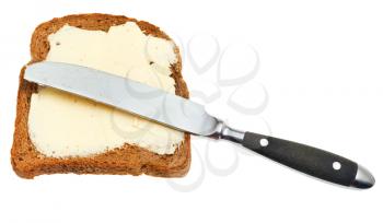 top view of rye bread and dairy butter sandwich and table knife isolated on white background