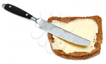 table knife on rye bread and dairy butter sandwich isolated on white background