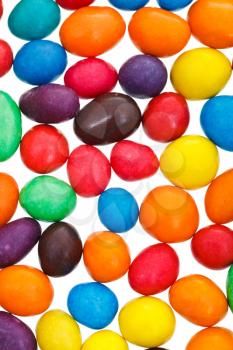 many multi-colored chocolate candy dragees isolated on white background