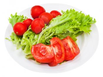 fresh lettuce and red tomatoes on white plate isolated on white background