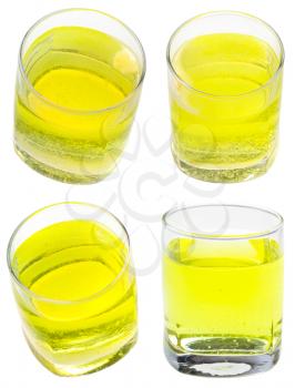 glass of yellow carbonated water with vitamin C isolated on white background