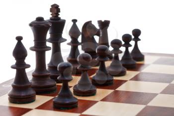 set of black chess pieces placed on chessboard close up