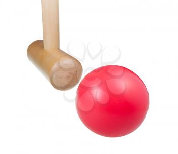 striking red ball by wooden mallet in croquet game close up isolated on white background