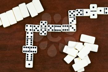 top view of dominoes playing on wooden table