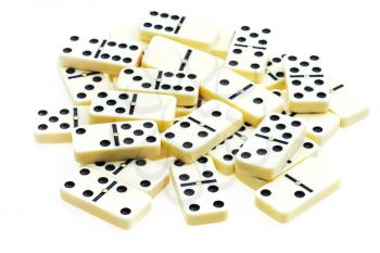pile of scattered dominoes on white background
