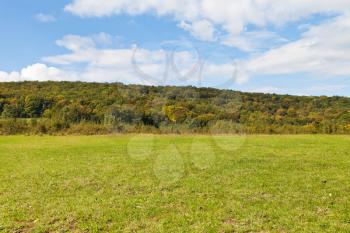 green meadow at foot of caucasian mountains in Shapsugskaya anomalous area in early autumn day