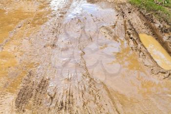 mud and puddle at dirt ground road in caucasus mountain