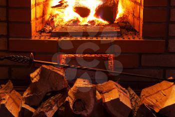 poker, firewood and near fireplace in evening time