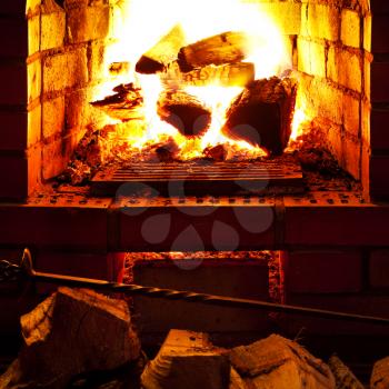 poker, firewood and near fireplace in evening time