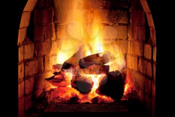 flames of fire in fireplace in evening time