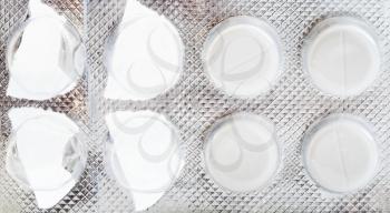 package of white pills close up