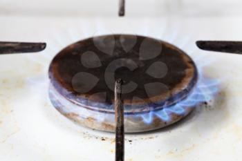 burning gas in hearth ring of kitchen stove