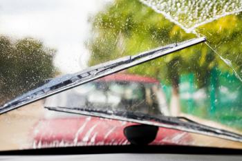 Car wipers wash windshield when driving in bad weather