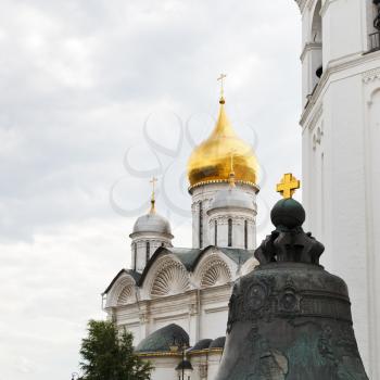 golden cross on Tsar bell and Archangel cathedral in Moscow Kremlin
