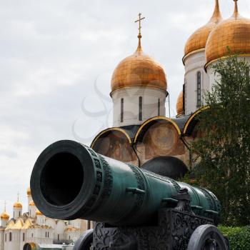 Tsar Cannon and gold dome of Dormition Cathedral in Moscow Kremlin