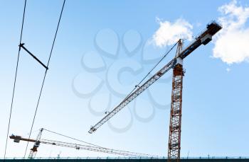 industrial crane under blue sky in summer evening