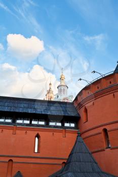 red wall and tower of historical Kitay-gorod and Zaikonospassky monastery in Moscow