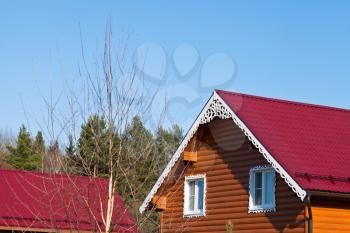red tile roofs of new wooden houses in country village