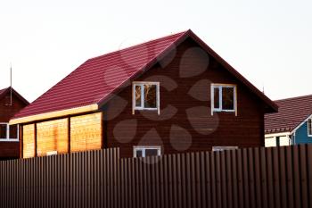 new wooden log house in country village in spring evening