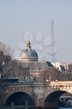 view of Eiffel Tower and French Academy through Pont Neuf in Paris
