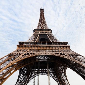 bottom view of Eiffel tower in Paris with blue sky and white clouds